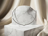 Sleek 18k white gold choker necklace on white marble pedestal