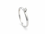 18K white gold diamond solitaire ring, three-quarter view showing the round brilliant-cut stone and polished band