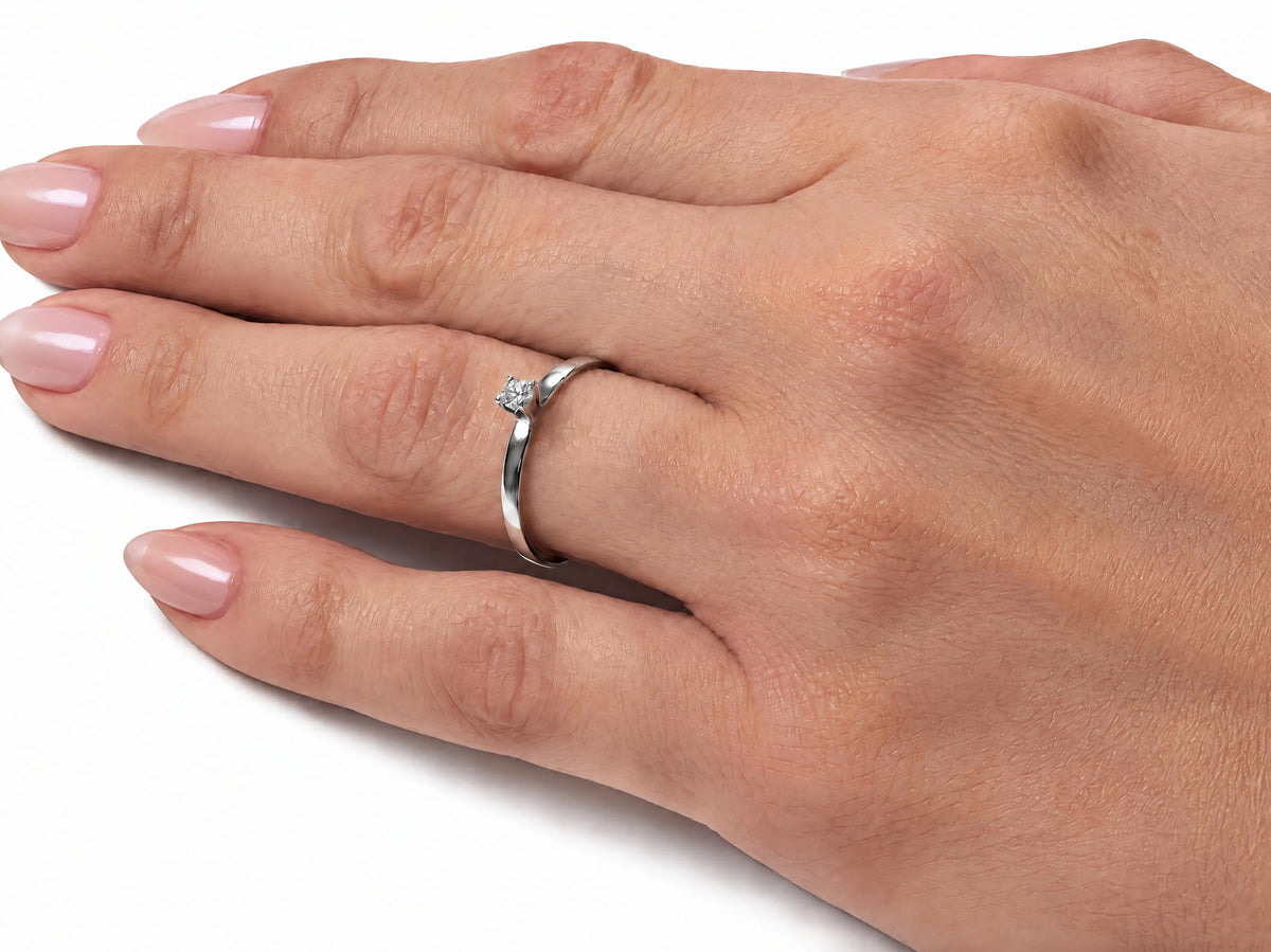 18K white gold diamond solitaire ring worn on the finger, close view