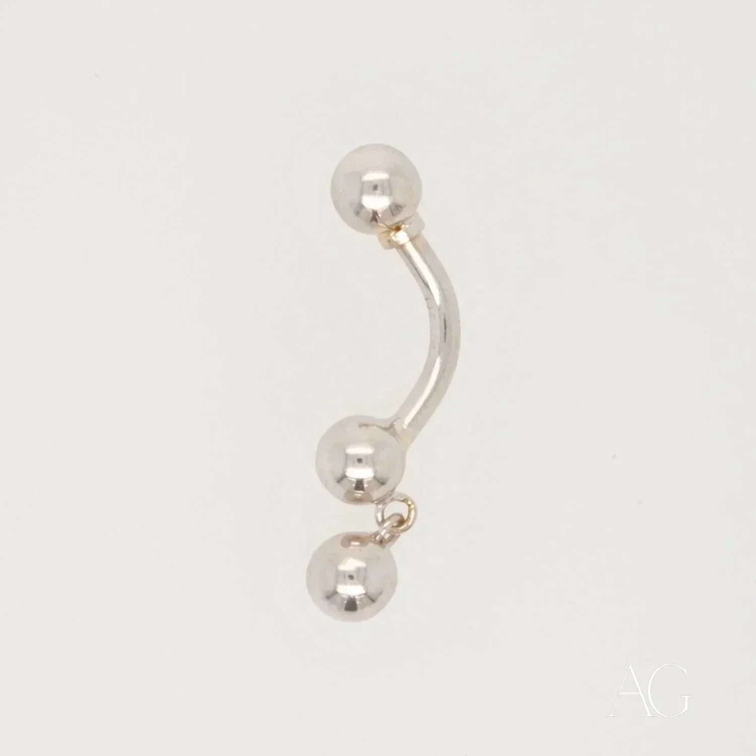 18k white gold curved barbell bellybutton piercing with dangling ball charm