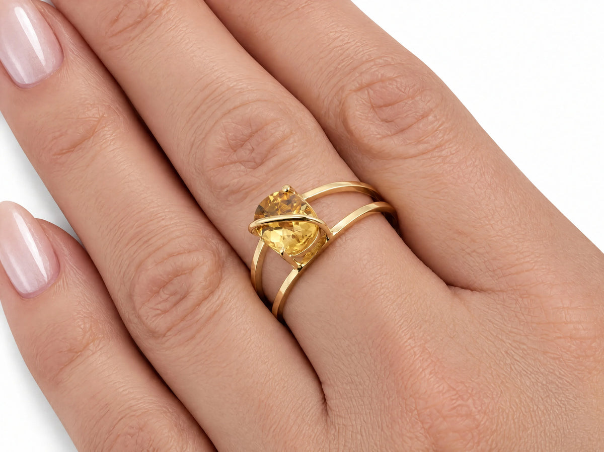 Close-up of the 18K yellow gold ArtGold citrine ring worn on a finger