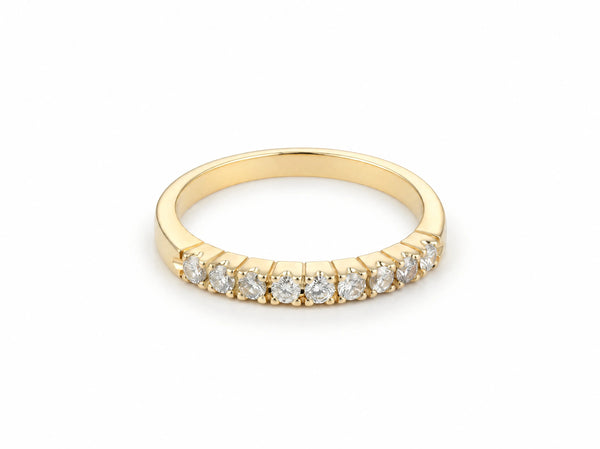 ArtGold 18K yellow gold half eternity band set with nine round diamonds in a single row, front view of the shared-prong setting and polished band
