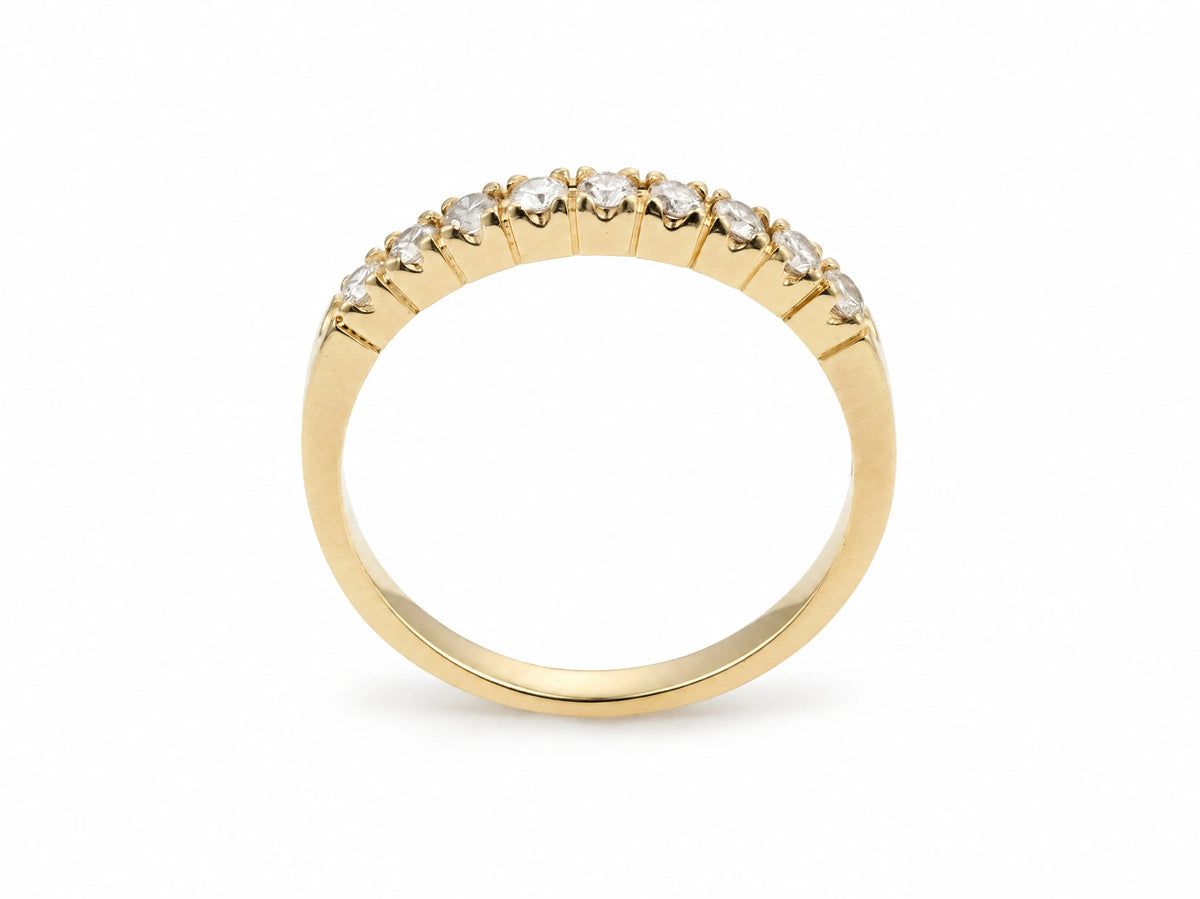 ArtGold 18K yellow gold half eternity diamond band, upright view of the nine round diamonds in their shared-prong setting