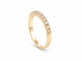 ArtGold 18K yellow gold half eternity diamond band, upright three-quarter view of the band and diamond row