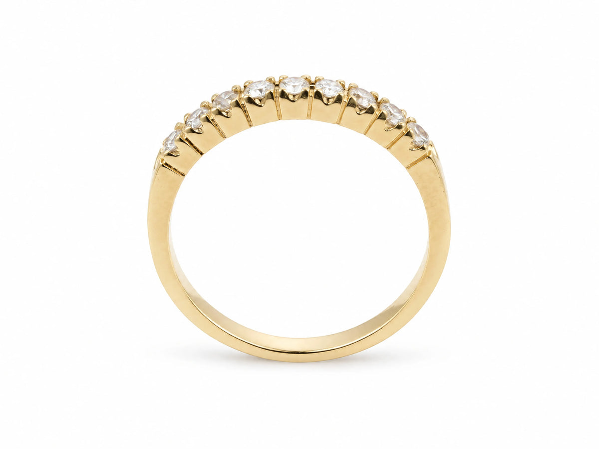 ArtGold 18K yellow gold half eternity diamond band standing upright, showing the polished band and the diamond row