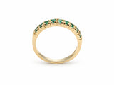 ArtGold 18K yellow gold half eternity emerald band, upright view of the nine round green emeralds in their shared-prong setting