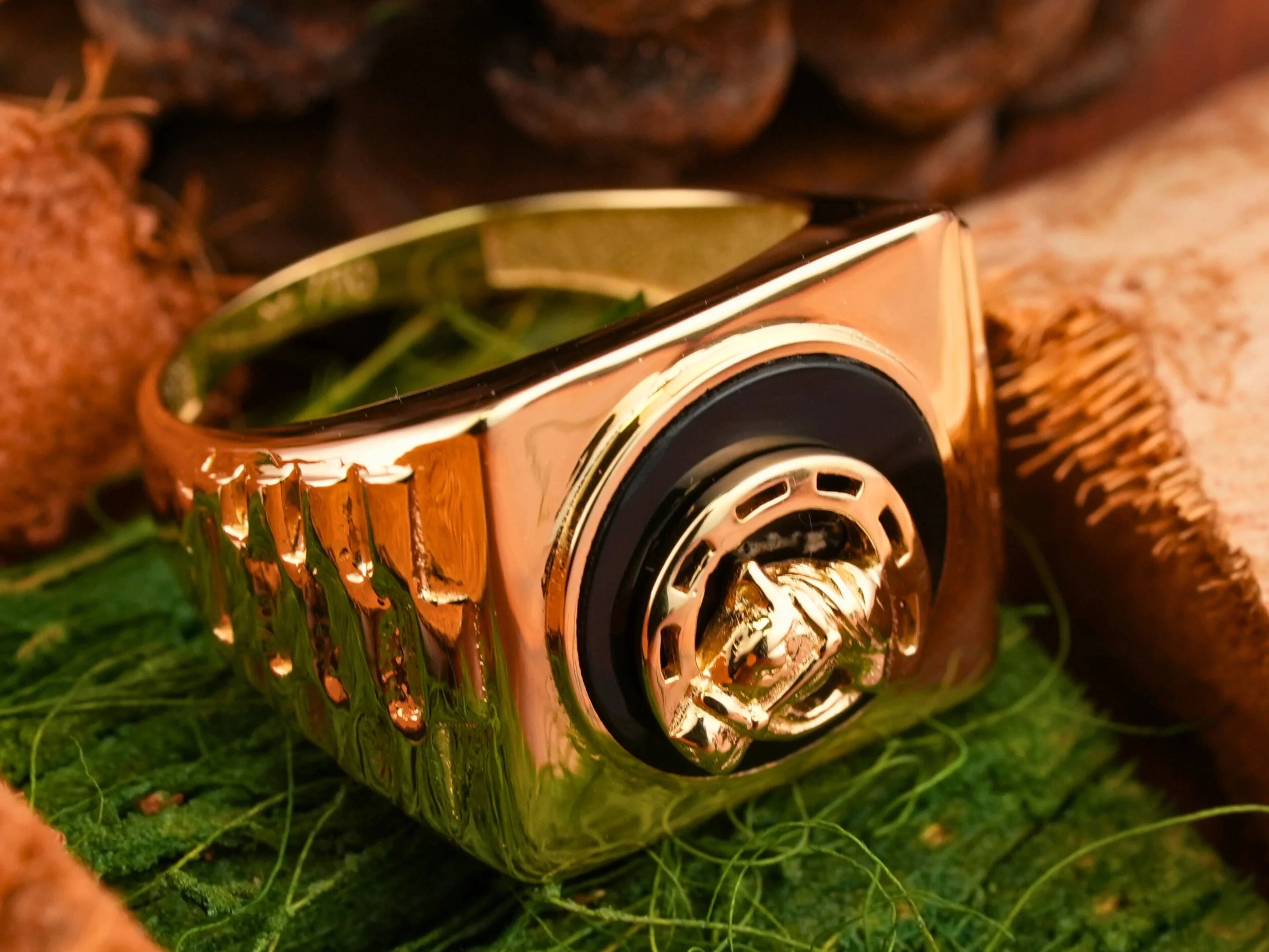 Shiny gold 18kg Onix Horse Shoes ring with horse shoe motif and black gold bull’s head design