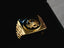 Golden signet ring with black onix horse shoes motif and intricate gold design