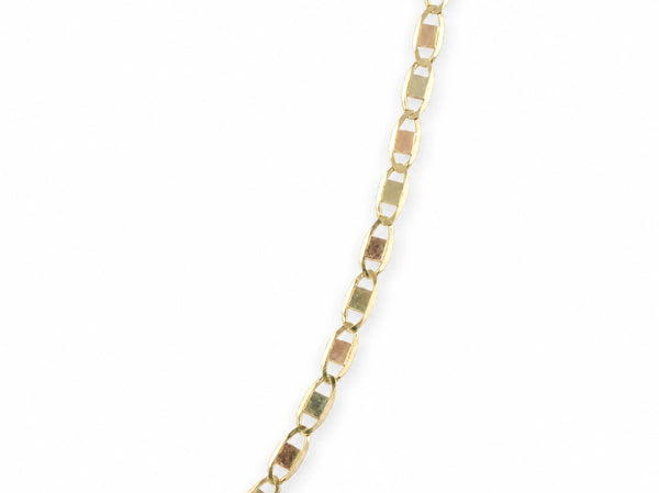14K gold piastrine chain at a 45 degree angle, showing the length of the oval links and the plates inside them