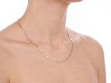 14K piastrine chain worn on a model, rear 45 degree view showing the chain draping across the upper back