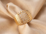 Malha 18K gold ring on champagne silk — two-tone yellow and white gold, diamond-cut band