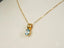 Gold necklace featuring a stunning blue topaz gemstone pendant in 18k gold