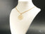 Gold-toned Blossom Spark Flower Pendant necklace featuring cubic zirconia detailing