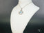 Silver pendant necklace with Blue Topaz in geometric design crafted from 18k White Gold