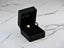 Gold stud earrings in a black jewelry box, showcasing Celestial Glow with timeless sparkle