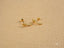 Gold Star Helix Earrings from Celestial Glow featuring a beaded crescent design