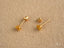 Pair of gold stud earrings featuring Celestial Spark 18k Gold Star CZ for kids