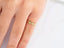 Gold ring with three diamonds in a delicate band of 18k yellow gold for every occasion