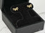 Gold bow earrings in a black jewelry box showcasing solid 18K gold artistry