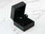 Diamond stud earrings in a black jewelry box showcasing certified 18K solid gold design