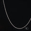 Dainty 14k white gold rope chain necklace on a dark background