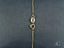 Gold necklace chain with clasp featuring polished gold spheres for a delicate look