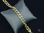 Gold chain bracelet on gray cushion showcasing elegant art gold jewelry style