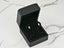 Pearl stud earrings in a black box showcasing elegant art gold jewelry design
