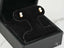 Pearl stud earrings in a black jewelry box, showcasing elegant art gold jewelry design