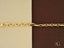 Elegant 18k solid gold men’s bracelet with lobster clasp on two-toned background