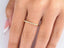 Delicate 18k yellow gold ring with small diamonds along the band for elegant style