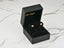 Gold butterfly earrings in a black jewelry box, featuring solid 18K gold design