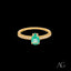 Elegant 18k gold ring with pear-shaped green emerald and diamond accents