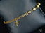 Elegant women’s 18k gold bracelet with cross motif and polished gold beads
