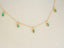 Elegant 18k Gold Emerald Necklace showcasing stunning marquise-cut emerald droplets