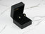 Emerald Halo 18K Gold Green CZ Earrings in a black jewelry box with teardrop design