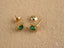 Gold halo stud earrings featuring green cubic zirconia for an emerald aura look