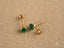 Gold and emerald stud earrings featuring green cubic zirconia in 18k gold settings