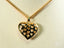 18k Gold Eternal Heart Pendant with cutout heart patterns on a delicate chain necklace