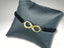 Bracelet featuring an 18k gold infinity charm on a durable nylon band