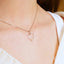 Heartfelt glint pendant in 14k gold with a heart-shaped design and small gold bead