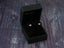 Black jewelry box showcasing Evil Eye CZ Earrings in certified 18k solid gold design