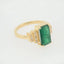 Exquisite 18k gold ring with 2.3ct emerald and diamond accents, displaying elegance and luxury.