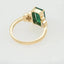 Exquisite 18k gold ring with 2.3ct emerald and diamond halo.