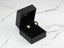 Gold clover earrings in a black jewelry box from Floral Elegance with 0.06ct diamond flower