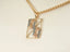 Gold-toned rectangular pendant with floral design on chain necklace from Golden Bloom