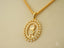 Gold pendant necklace featuring a boy design in 18k gold surrounded by crystals