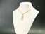 18k gold Golden Cherish Pendant featuring a boy-shaped design on a display bust