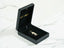 Black jewelry box showcasing a Golden Doll 18k Gold Doll Pendant inside