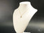 18k gold Dragonfly Pendant necklace on a white jewelry bust for elegant display